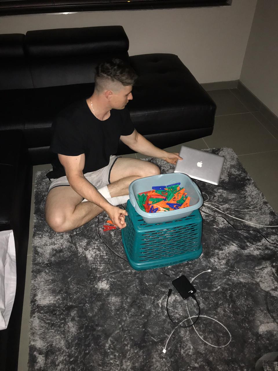 Timon working from a laptop in his dad's garage